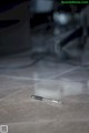 A pen sitting on the floor in a dark room.