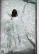 A black and white photo of a person swimming in a pool.