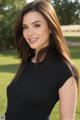 A woman in a black dress posing for a picture.
