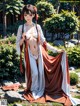 A woman in a kimono is posing for a picture.