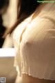 A close up of a woman's breasts in a white shirt.