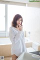 A woman standing in a bathroom next to a sink.